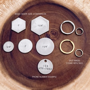May include: A comparison of different sizes of metal tags for keychains or jewelry. The tags are round, hexagonal, and round with a split ring. The tags are made of silver metal and have measurements in inches. The image also shows a silver tag with a phone number example.