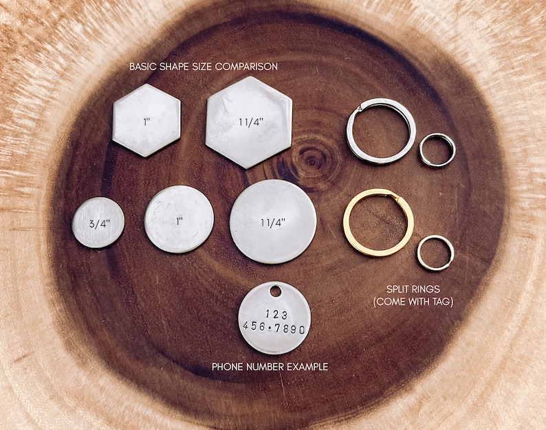 May include: A comparison of different sizes of metal tags for keychains or jewelry. The tags are round, hexagonal, and round with a split ring. The tags are made of silver metal and have measurements in inches. The image also shows a silver tag with a phone number example.