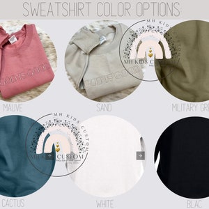 May include: A selection of sweatshirts in various colors, including mauve, sand, military green, cactus, white, and black. The sweatshirts feature the text "God is Good" in a white font.