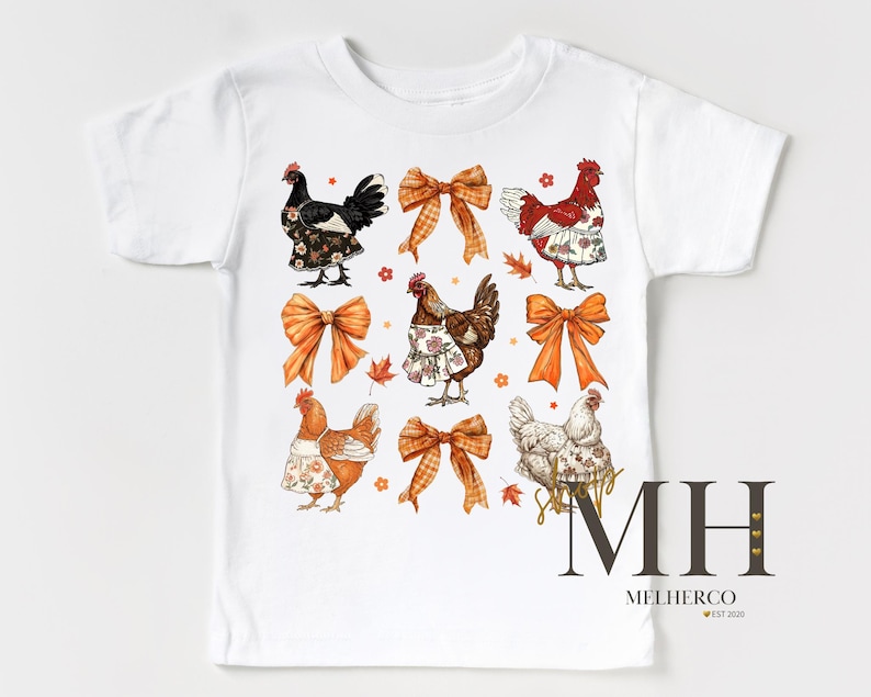 May include: White t-shirt featuring a colorful graphic of chickens wearing aprons and bows. The design includes orange bows and autumn leaves. The text "MH MELHERCO EST 2020" is printed on the bottom right.