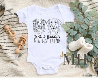 May include: White baby onesie with black line drawings of two dogs and the text "Jack & Buddy's New Best Friend".
