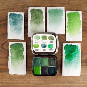 Handmade watercolor palette with 6  green colors. Handmade paint. 6 half pans in a metal tin. Art supply.
Green watercolor paint.