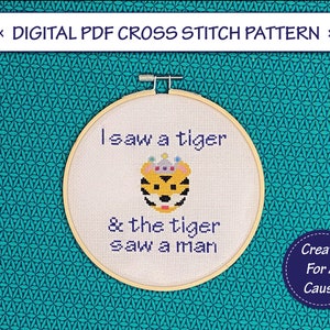 May include: A cross stitch pattern featuring a tiger wearing a crown with the text "I saw a tiger & the tiger saw a man".