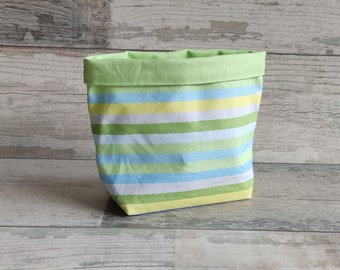 Small utensil with fresh green and blue stripes - practical and stylish - with a small color error