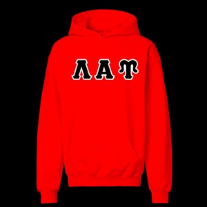 May include: A bright red hooded sweatshirt featuring long sleeves and a front kangaroo pocket. The center of the chest displays the Greek letters Lambda, Alpha, and Tau in white with a thick black outline, creating a bold contrast against the red fabric.