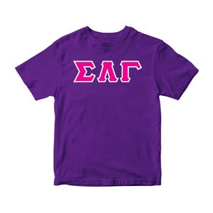 May include: Purple t-shirt with a white outline and pink letters that spell "ΣΑΓ"