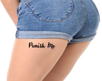 May include: A woman wearing denim shorts with the text "Punish Me" written in black cursive on her thigh.