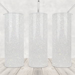 May include: Three white glitter tumbler cups with clear lids and straws. The tumblers are on a light wood surface.