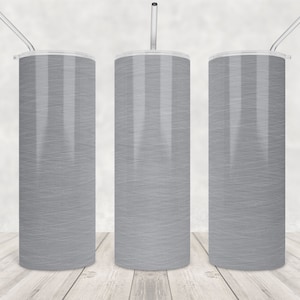 May include: Three tall, cylindrical tumblers with a light grey, textured design. Each tumbler has a clear lid and a silver-coloured straw. The tumblers are displayed on a light wood surface.