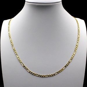 May include: A gold chain necklace with a figaro link pattern. The chain is displayed on a white mannequin bust.
