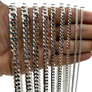 May include: A collection of silver curb chains in various widths, ranging from 2.5mm to 10mm. The chains are displayed against a neutral background, showcasing their polished, reflective surfaces. The image highlights the different sizes available.