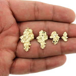May include: Four gold nugget pendants of varying sizes. The pendants are made of 10k gold and have a textured, irregular shape.