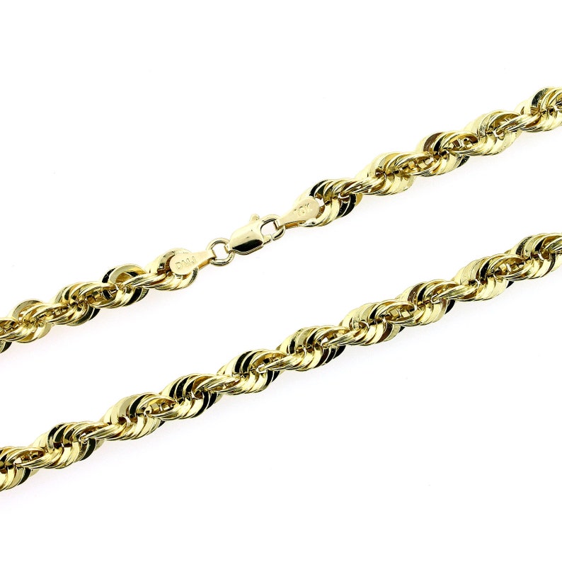May include: A gold rope chain necklace with a lobster clasp closure.
