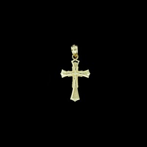 May include: A gold cross pendant with a detailed design. The cross has a textured surface and a small loop at the top for attaching a chain.