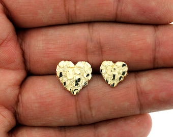 May include: A pair of gold heart-shaped earrings with a textured diamond-cut finish.