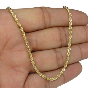 May include: A gold rope chain necklace. The chain is made of a series of small, twisted links that create a rope-like appearance.