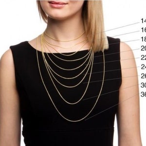 May include: A model wears a gold chain necklace in various lengths, from 14 inches to 36 inches. The lengths are labeled on the right side of the image.