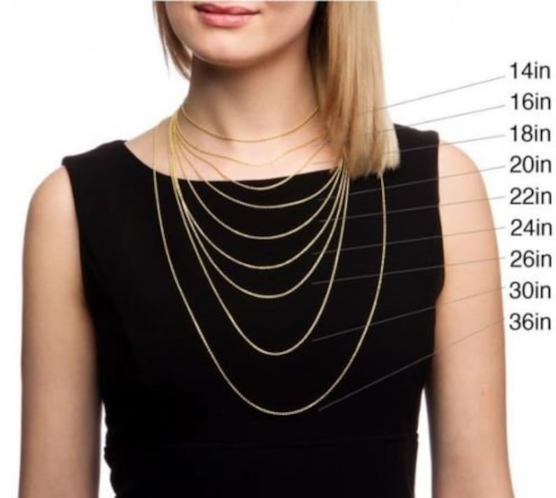 May include: A model wears a gold chain necklace in various lengths, from 14 inches to 36 inches. The lengths are labeled on the right side of the image.