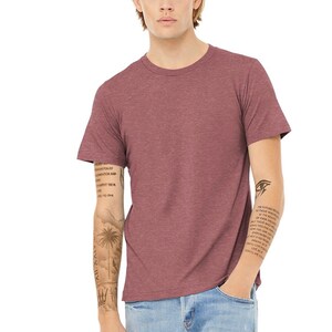 May include: A heather red short-sleeved t-shirt with a crew neck. The t-shirt is made of a soft, comfortable material and has a relaxed fit.