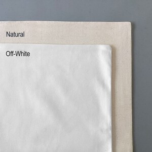 May include: Two pieces of fabric, one labeled "Natural" and the other labeled "Off-White". The fabric is a natural linen or cotton blend.
