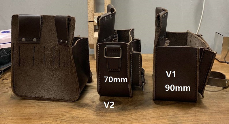 May include: Three brown leather tool bags with different sizes. The bag on the left is the smallest, the middle bag is slightly larger, and the bag on the right is the largest. The middle bag has a label that says "70mm V2" and the right bag has a label that says "90mm V1".