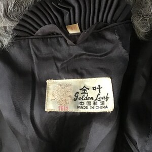 May include: A black fur coat with a black satin lining and a label that reads "Golden Leaf, Made in China" in English and Chinese.