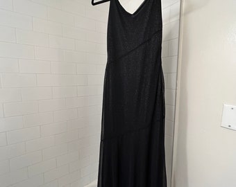 May include: A black sparkly sleeveless maxi dress with a V-neckline hanging on a black hanger in a bathroom.