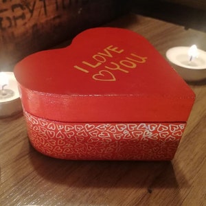 a wooden box painted with acrylic paints and varnish. Valentine's Day gift box. Heart-shaped box, handicraft.