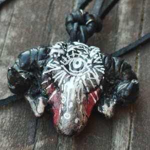 The mystery of the black ram shedding blood with closed eyes, featuring the all-seeing eye symbol
