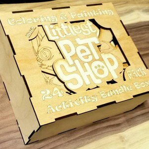 May include: A wooden box with the words "Littlest Pet Shop" and "24 Activity Bundle Pack" printed on it. The box is decorated with a cartoon image of a pet.