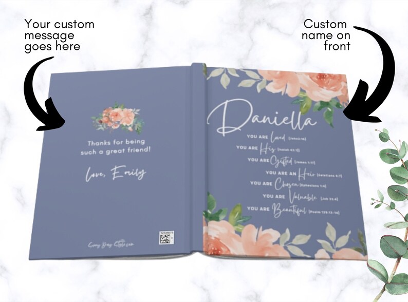 May include: A blue hardback book with a floral design. The front cover features the name Daniella and a list of affirmations with scripture references. The back cover includes a custom message, Thanks for being such a great friend! Love, Emily.