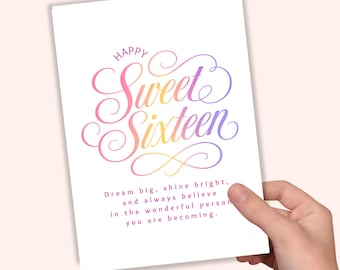May include: A white greeting card featuring the text Happy Sweet Sixteen in a colorful gradient script font. Below the main text, the card includes the printed message: Dream big, shine bright, and always believe in the wonderful person you are becoming.