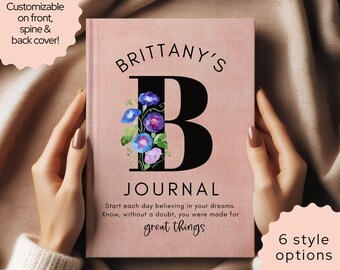 May include: A dusty rose journal with a large black letter B featuring blue and purple morning glory flowers. The text reads: BRITTANY'S B JOURNAL. Start each day believing in your dreams. Know, without a doubt, you were made for great things.