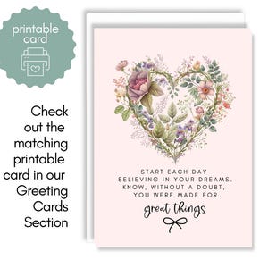 May include: A pale pink greeting card featuring a heart-shaped wreath made of various colorful flowers and green leaves. Below the floral heart, the text reads: START EACH DAY BELIEVING IN YOUR DREAMS. KNOW, WITHOUT A DOUBT, YOU WERE MADE FOR great things.