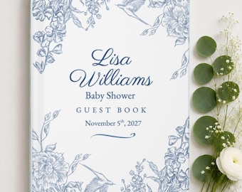 May include: A white guest book with blue floral and bird illustrations. The text reads: Lisa Williams, Baby Shower, GUEST BOOK, November 5th, 2027. The cover features a decorative border of sketched flowers and birds in a blue ink style.