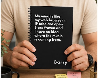 May include: A black spiral-bound notebook featuring white text that reads: My mind is like my web browser - 19 tabs are open, 3 are frozen and I have no idea where the music is coming from. The name Barry is printed in white at the bottom right corner.