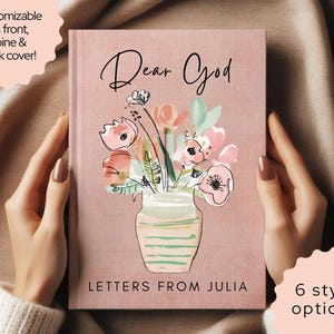 May include: A pink journal with the words "Dear God" in elegant script. The cover features a watercolor illustration of flowers in a vase. The text "Letters From Julia" is at the bottom. Customizable on front, spine & back cover.