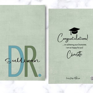 May include: A green card with the text "Congratulations! ... on achieving your Doctorate, I am so happy for you! Charlotte" and a black graduation cap icon. The card also has the text "Dr. Sullivan" in blue and green letters.