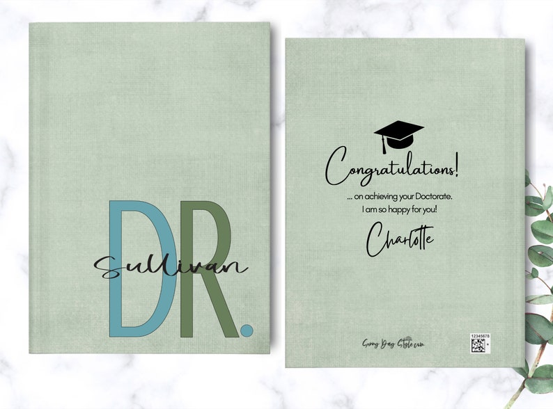 May include: A green card with the text "Congratulations! ... on achieving your Doctorate, I am so happy for you! Charlotte" and a black graduation cap icon. The card also has the text "Dr. Sullivan" in blue and green letters.
