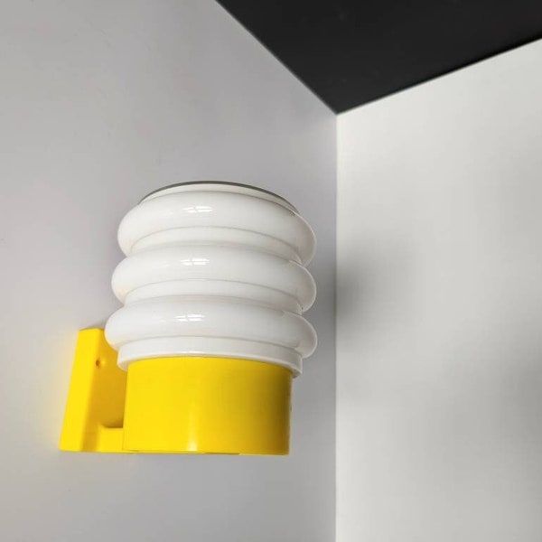 Unused vintage! Swedish 70s wall lamp with milk white opal glass and plastic mount in bright yellow. Playful bubble shade. NEW OLD STOCK