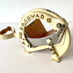 Vintage Danish Raadvad bread slicer / cutter in cream with gold accent. Model 294. Made in Denmark, 1960s. For use or display.