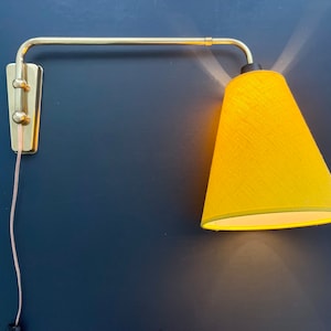 Rare swing arm wall lamp made in shiny brass - Scandinavian adjustable design telescopic tube from around the 50-60s. with new yellow shade.