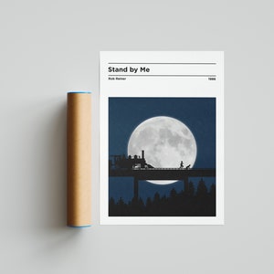 May include: A minimalist poster featuring a black silhouette of a train on a bridge beneath a large, full moon. The text "Stand by Me" is at the top of the poster, with the director's name "Rob Reiner" and the year "1986" below it.
