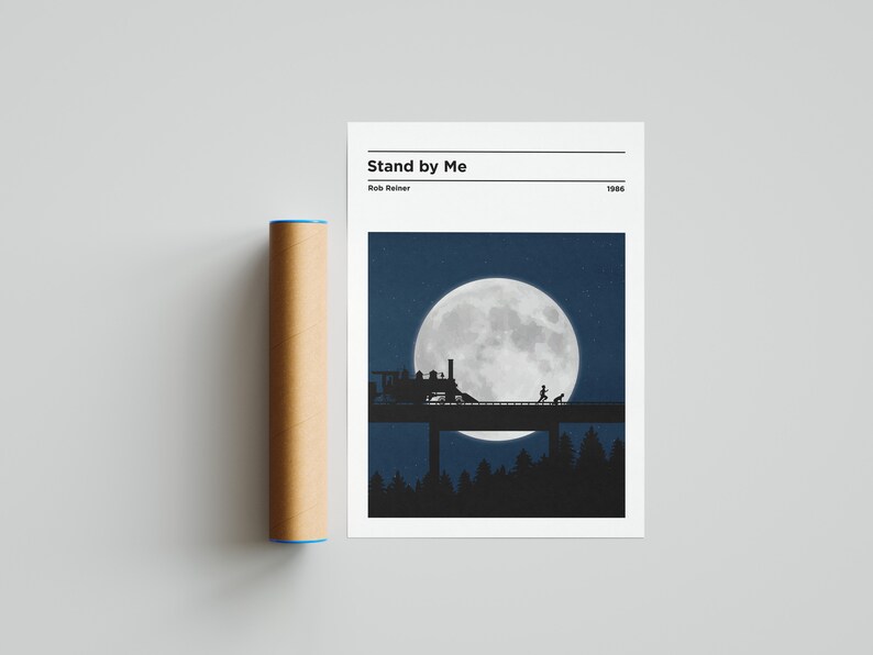 May include: A minimalist poster featuring a black silhouette of a train on a bridge beneath a large, full moon. The text "Stand by Me" is at the top of the poster, with the director's name "Rob Reiner" and the year "1986" below it.