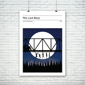 May include: A minimalist poster with a black silhouette of a bridge with people hanging from it, a full moon, and a starry night sky. The text "The Lost Boys" and "Joel Schumacher" are at the top of the poster, and the year "1987" is at the bottom.