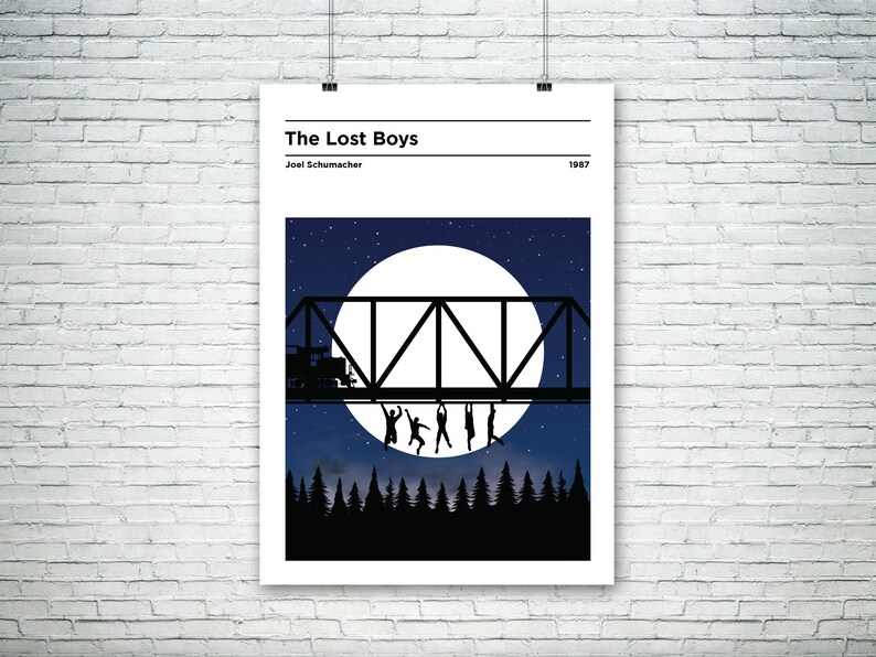 May include: A minimalist poster with a black silhouette of a bridge with people hanging from it, a full moon, and a starry night sky. The text "The Lost Boys" and "Joel Schumacher" are at the top of the poster, and the year "1987" is at the bottom.