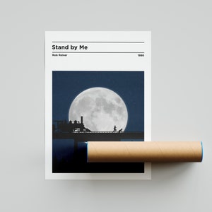 May include: A minimalist movie poster design for the film "Stand by Me" directed by Rob Reiner. The poster features a silhouette of a train crossing a bridge under a large, full moon.