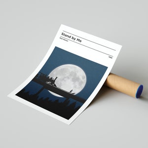 May include: A minimalist movie poster for the film "Stand by Me" directed by Rob Reiner. The poster features a silhouette of a train crossing a bridge under a large, full moon in a dark blue sky.