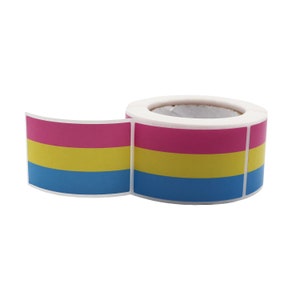 Könnte beinhalten: Eine Rolle Aufkleber mit einem horizontal gestreiften Design in Pink, Gelb und Blau. Die Aufkleber befinden sich auf einer weißen Rolle. Die Farben sind lebendig, und die Aufkleber dienen wahrscheinlich zum Beschriften oder Dekorieren.