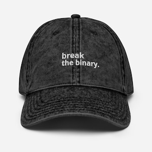 May include: A black vintage washed cotton baseball cap with the text "break the binary" embroidered in white on the front.